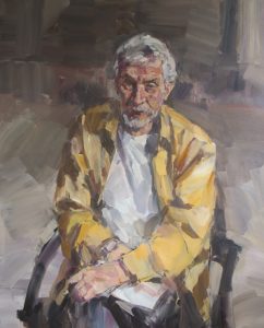 portrait of man in yellow shirt